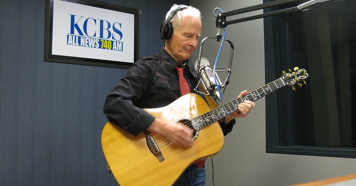 Dr. Elmo, who recorded Grandma Got Run Over by a Reindeer, plays acoustic guitar into a studio microphone at KCBS radio in San Francisco in November 2010